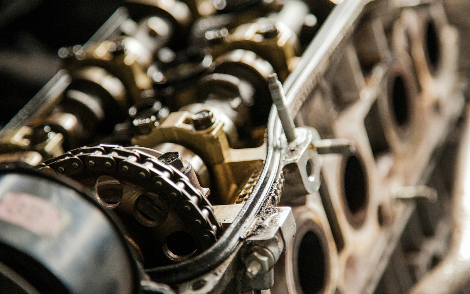 Detailed close-up of a modern car engine with visible cylinders, belts, and mechanical parts and components